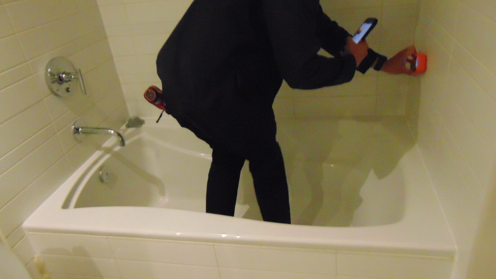 Testing bathtub and shower fixtures during a home inspection